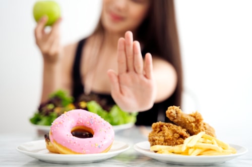 Woman avoiding fried foods and eating healthier