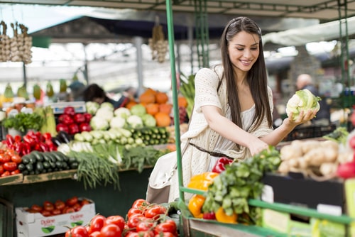 Woman buying vegetables at farmer's market