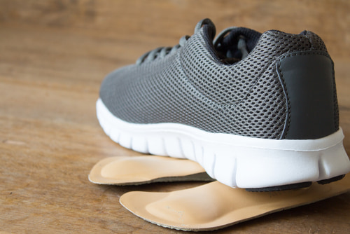 Adding insoles to walking shoes