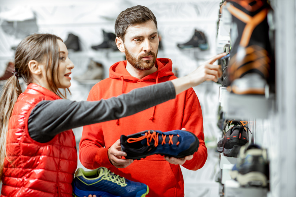 Man and woman picking the perfect walking shoe