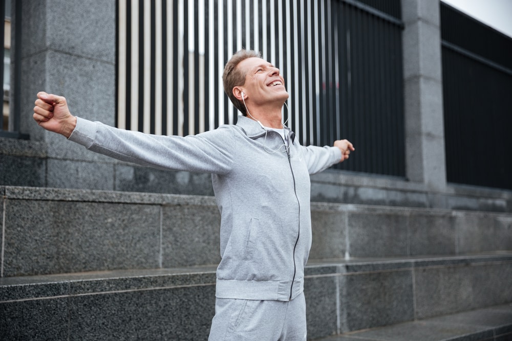 Man celebrating from hitting his exercise goals