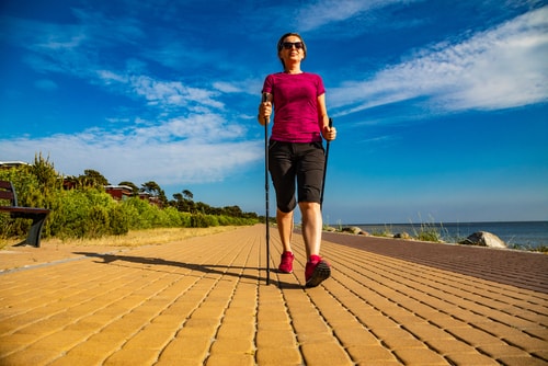 Woman Nordic Walking near the ocean