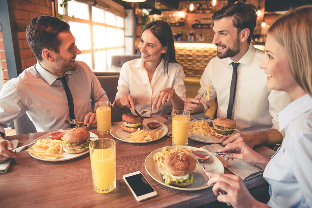 Coworkers eating lunch together