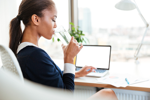 woman drinking water in the office