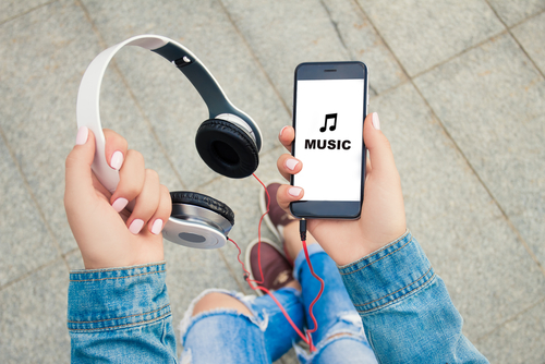 Phone and headphones - listening to music concept