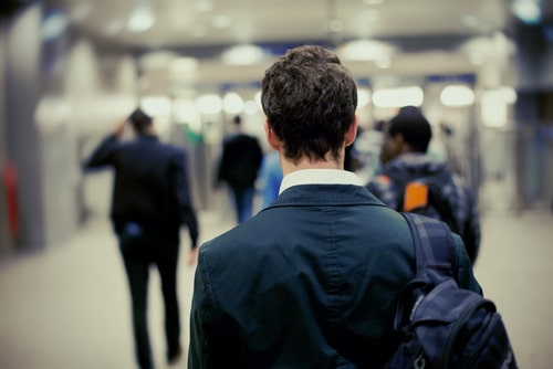 Back view of businessperson walking on a subway