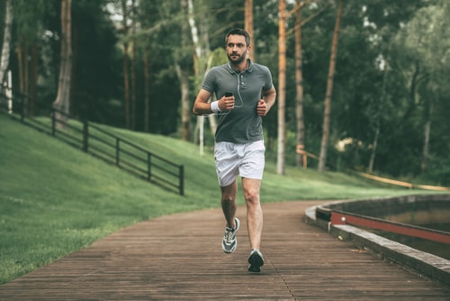 Man walking fast on a waterside trail