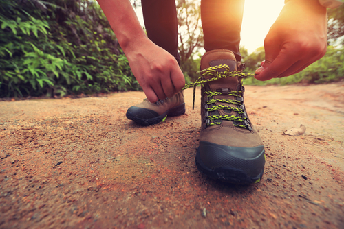 Hiking boots being tied for walking