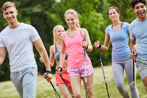 Group of friends walking with poles