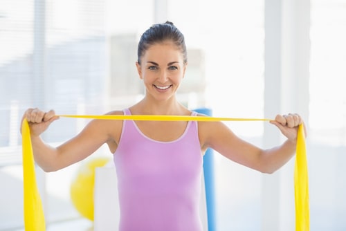 Woman showing off exercise resistance band