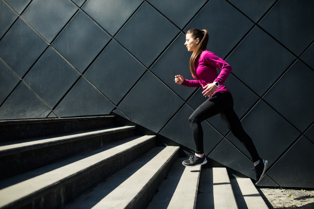 Sporty woman walking up stairs