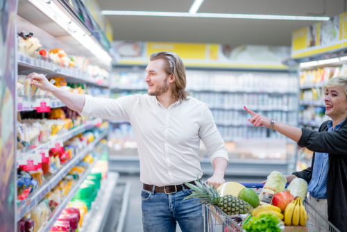 Couple choosing healthy snacks at the supermarket