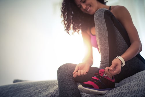 Woman tying shoes and getting ready to walk