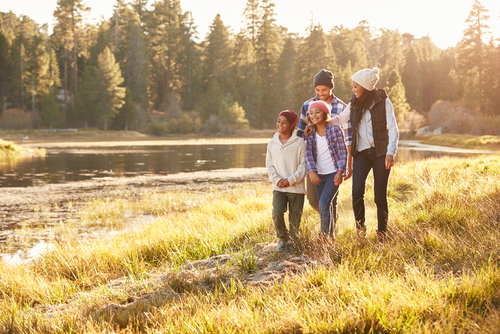 Family hiking together near lake