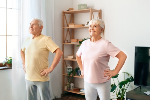Senior couple doing dance exercise at home