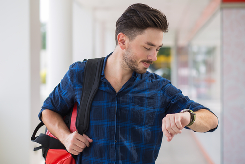 Man checking watch with activity tracker installed to check his steps and calories burned