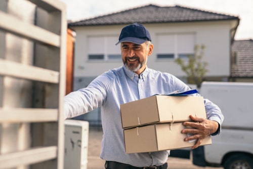 Postal worker delivering packages