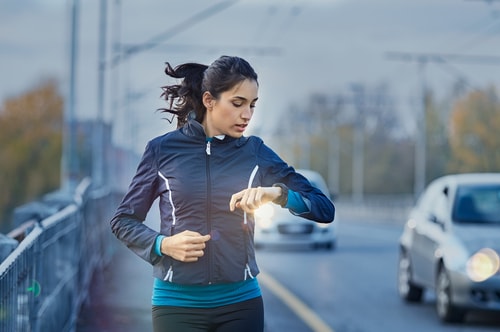 Woman walking on the roadside in the evening