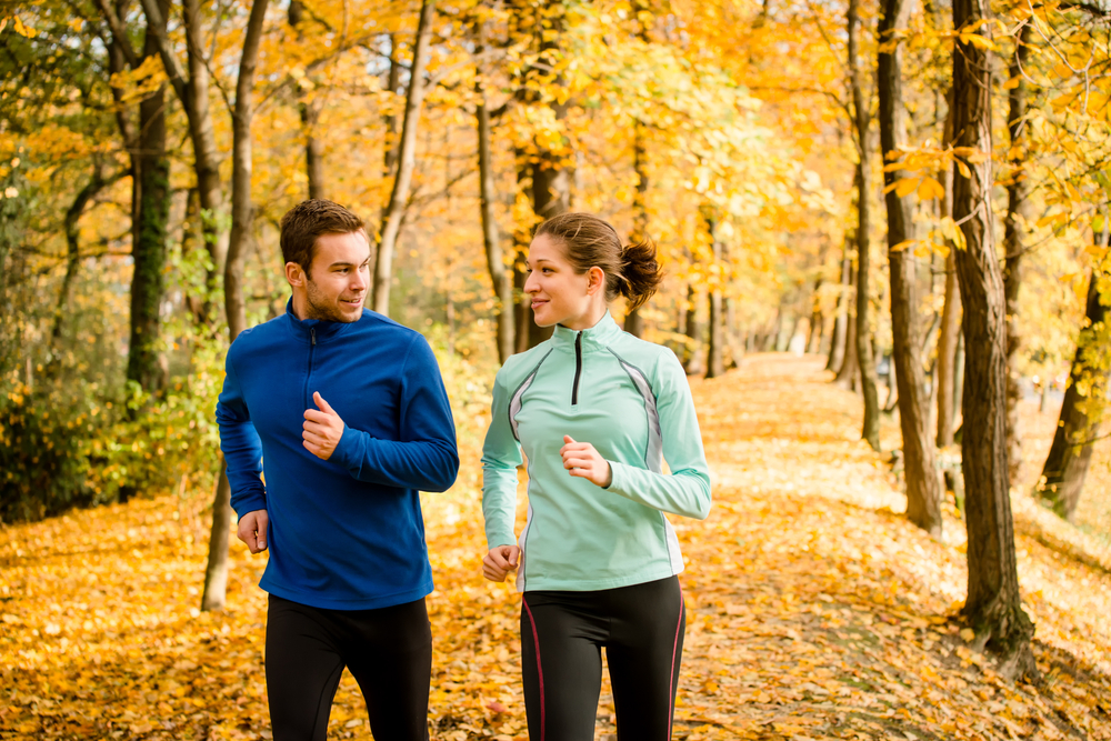 Couple walking for fitness in an autumn park
