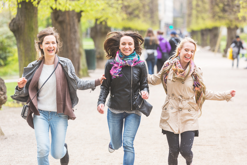 Women walking and jumping in the park