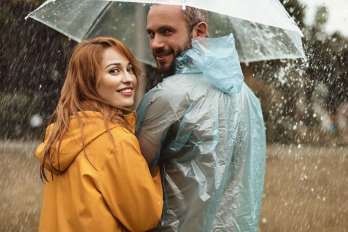 Couple with rain gear walking in rain