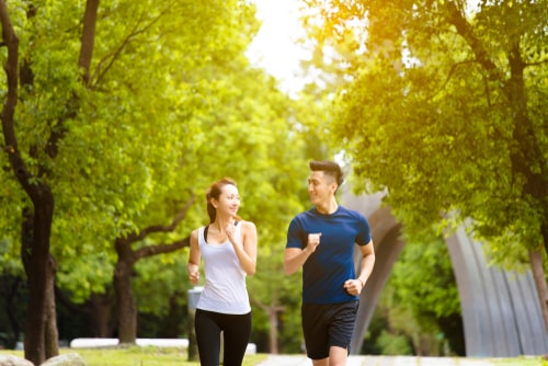 Man and woman power walking for fitness