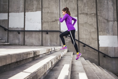Woman climbing stairs to burn more calories