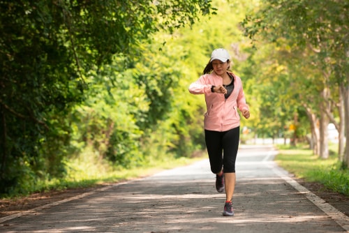 Woman checking her watch during a walk in the park