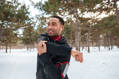 Man warming up before a walk or jog in winter