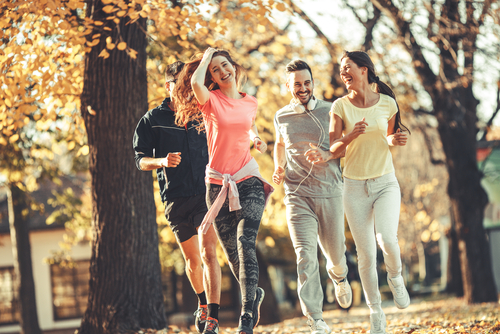 Friends jogging on the street in the fall