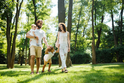 Happy family walking in a natural park setting