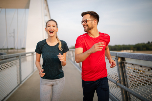 Couple jogging on a bridge for fitness