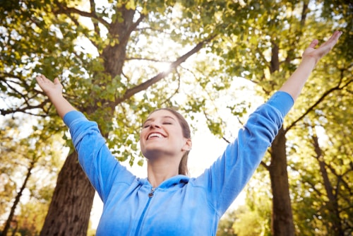 Woman celebrating in a sunny park