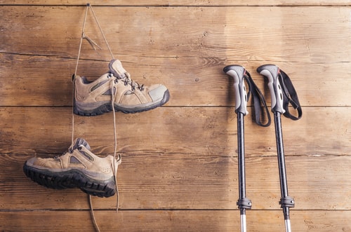 Walking shoes and Nordic walking poles on wall