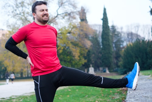 Man holding sore back after exercise