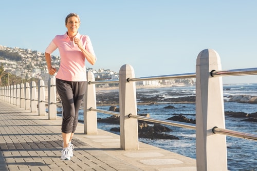 Woman walking for fitness near the ocean