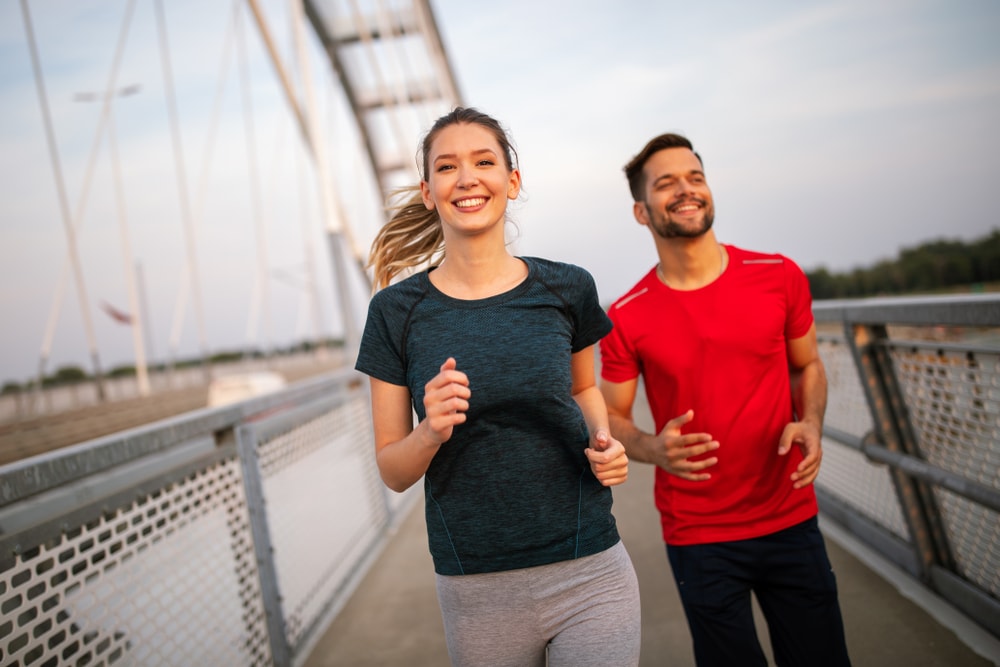 Couple walking for fitness on a bridge