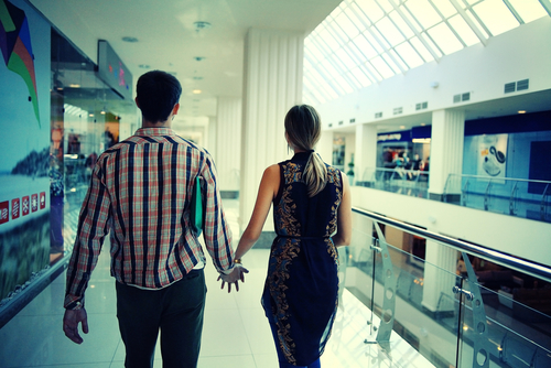 Man and woman walking indoors in a mall