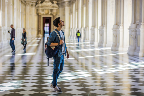 Man walking indoors in a museum