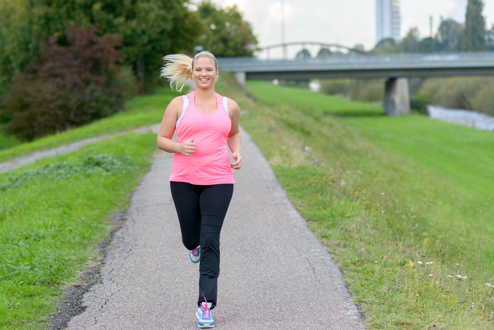 Plus sized female jogger on running path
