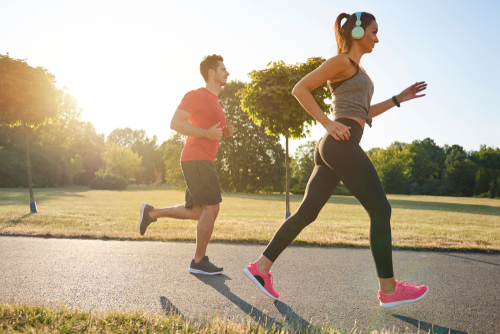 Man and woman fitness walking in the park