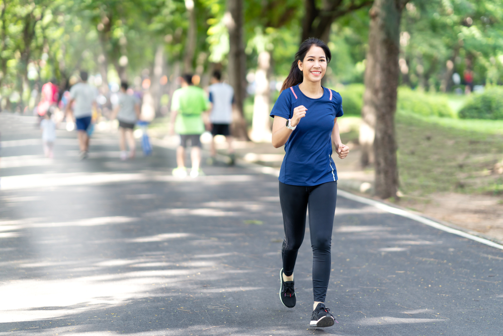 Athletic woman fitness walking in the park