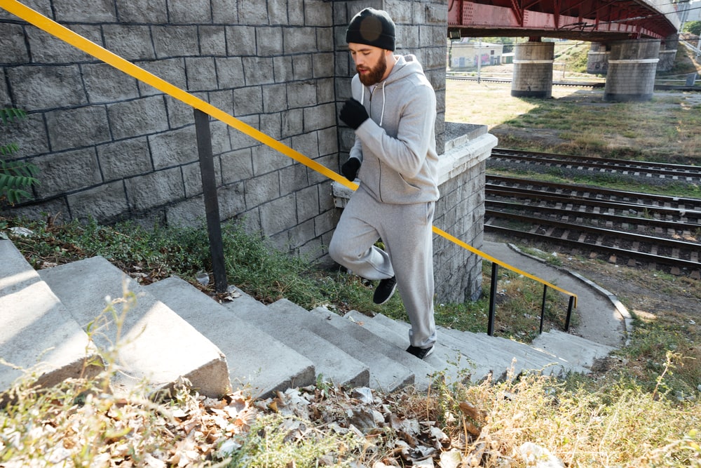Man walking up stairs as an intense workout