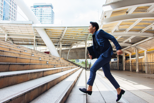 Businessman walking up stairs for a workout