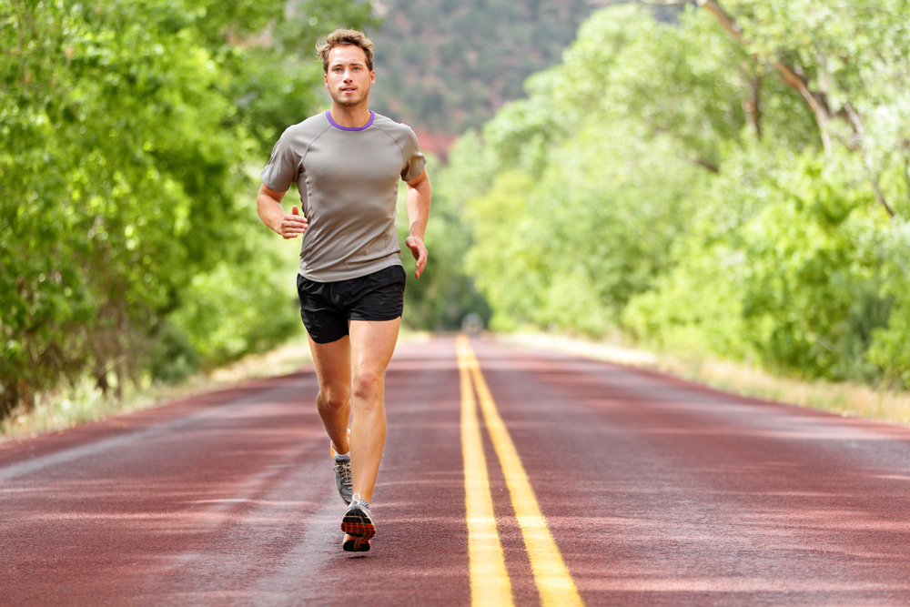 Man walking fast for fitness on country road