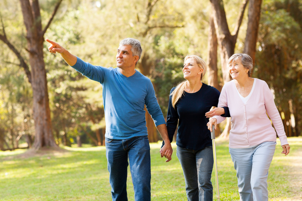 Couple and mom walking in park for fitness