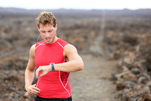 Man checking fitness watch after long jog