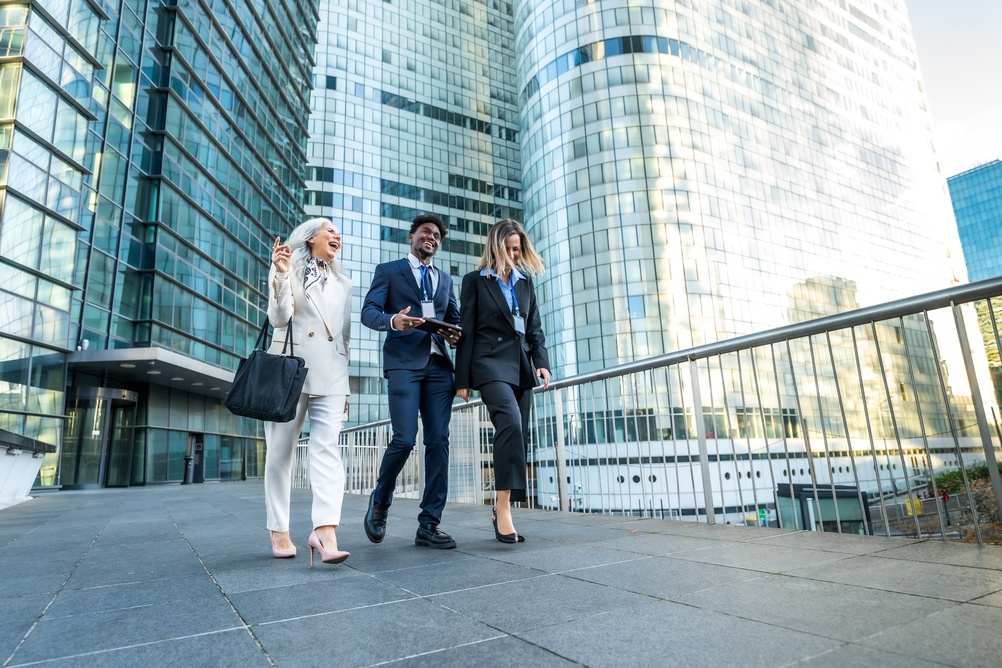 Three colleagues walking together outside the office during a workplace step challenge