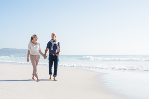 Older couple going for a leisurely walk on the beach