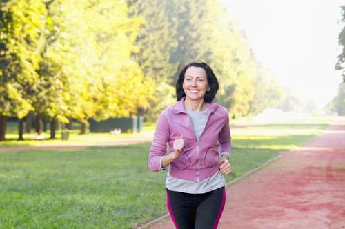 Senior woman walking for fitness in the park